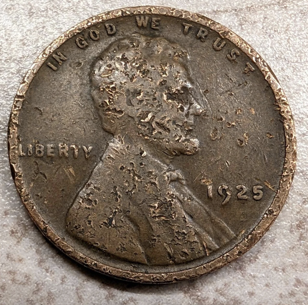 Worn 1925 Lincoln penny, showing significant wear and tear with obscured features