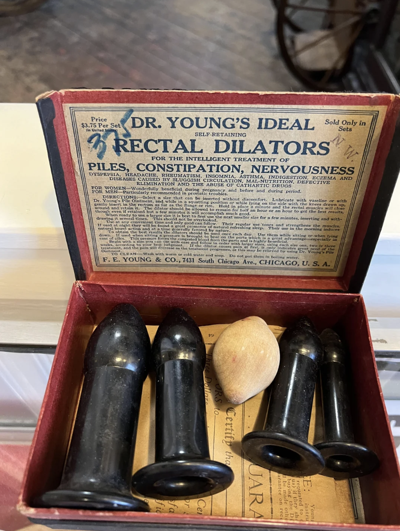 Vintage Dr Young&#x27;s Ideal Rectal Dilators set, looking like butt plugs of various sizes, with box and instructions, intended for treating various ailments, including piles, constipation, and &quot;nervousness&quot;