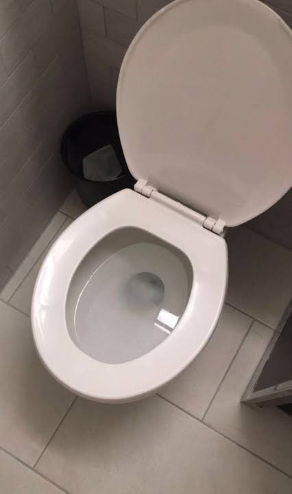 Open toilet bowl in a bathroom
