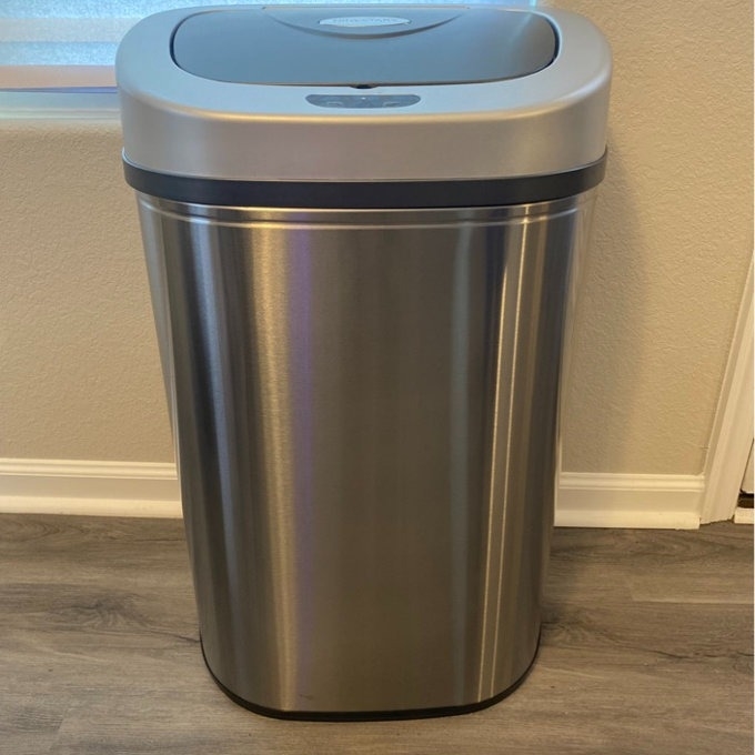 Stainless steel automatic trash can with a sensor lid in a home setting