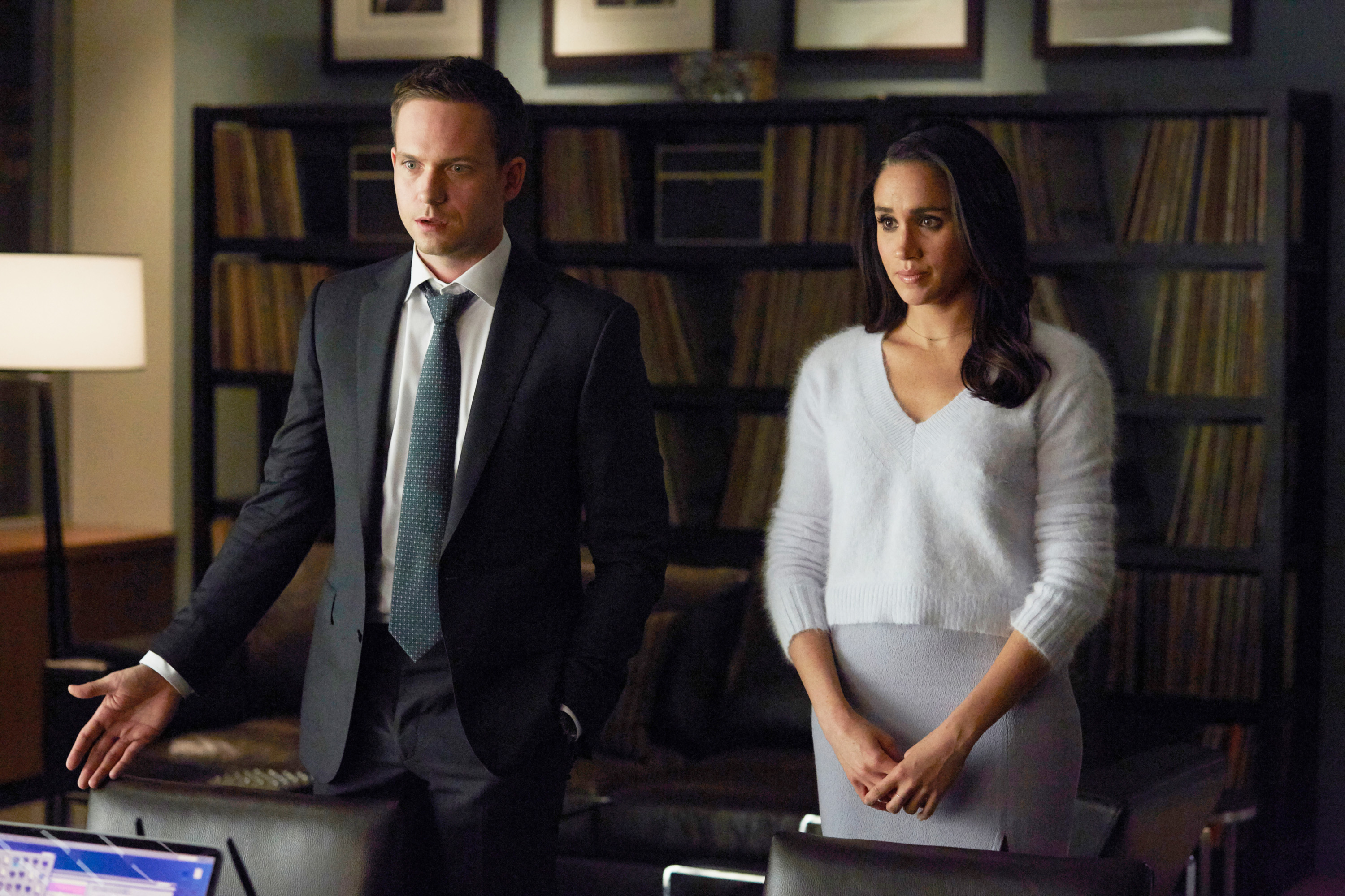 Michael Ross, played by Patrick J. Adams, and Rachel Zane, played by Meghan Markle, standing side by side in an office