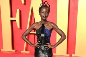 Lupita Nyong'o poses in a shimmering, halter-neck gown at an event