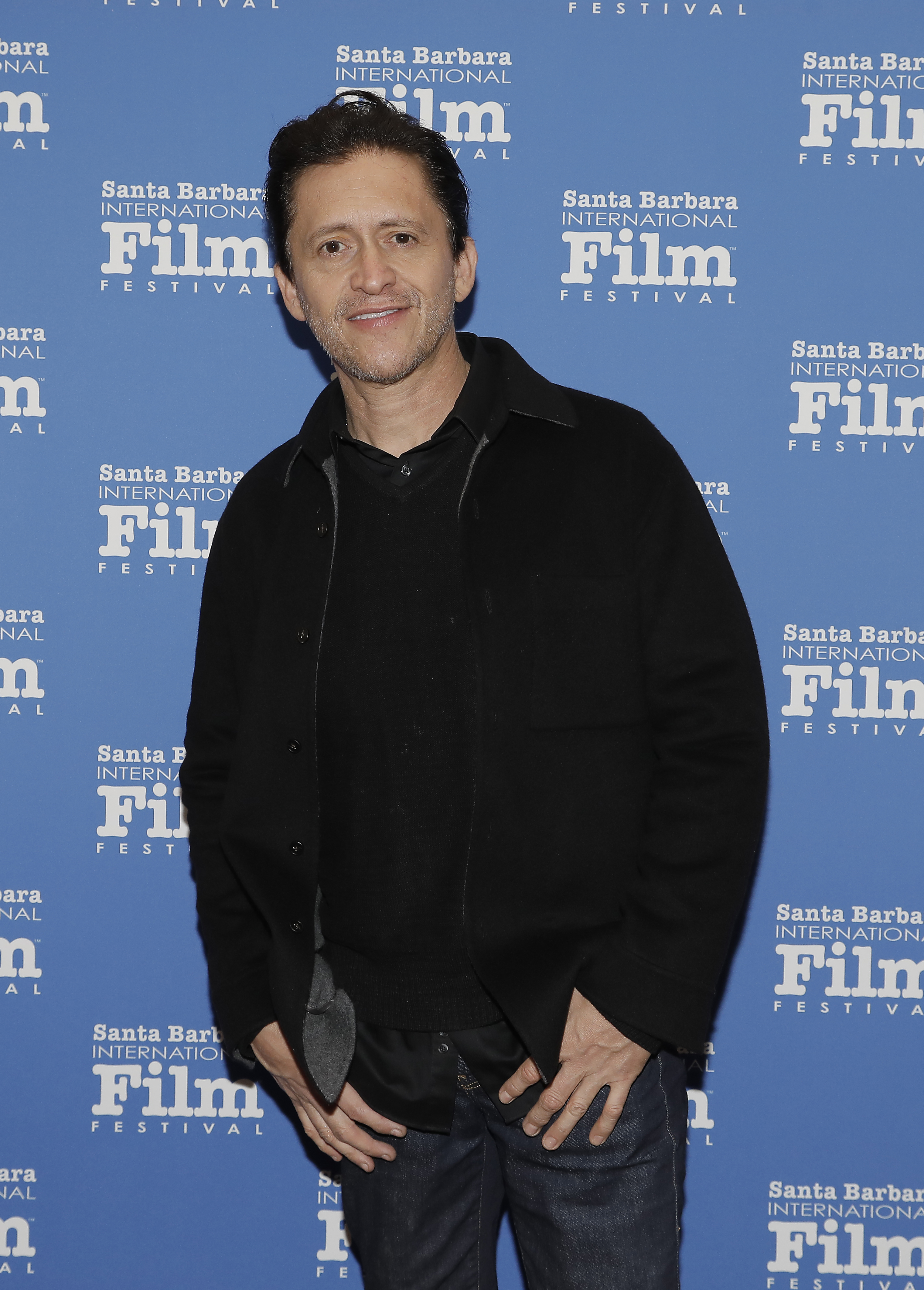 Clifton Collins Jr. stands on the Santa Barbara International Film Festival red carpet in a casual jacket and shirt