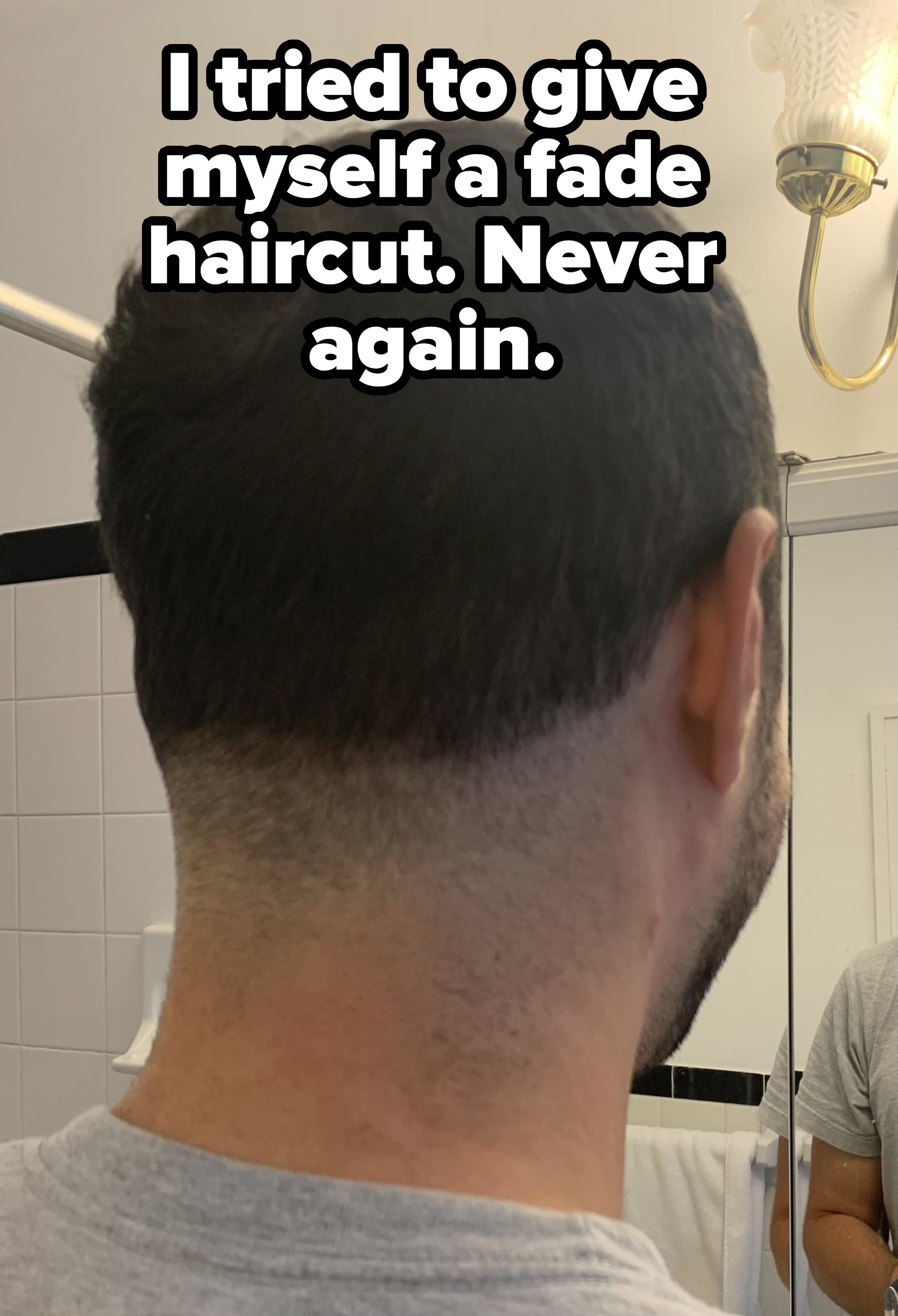 Person with a short back and sides haircut that was supposed to be a fade, viewed from the back