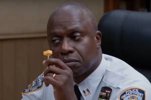 Captain Holt from Brooklyn Nine Nine holding a toothpick with cheese on it