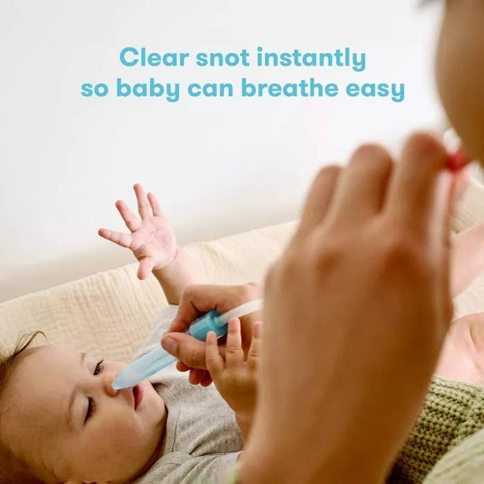 Parent using a nasal aspirator on a baby to clear their nose. Text: &quot;Clear snot instantly so baby can breathe easy&quot;