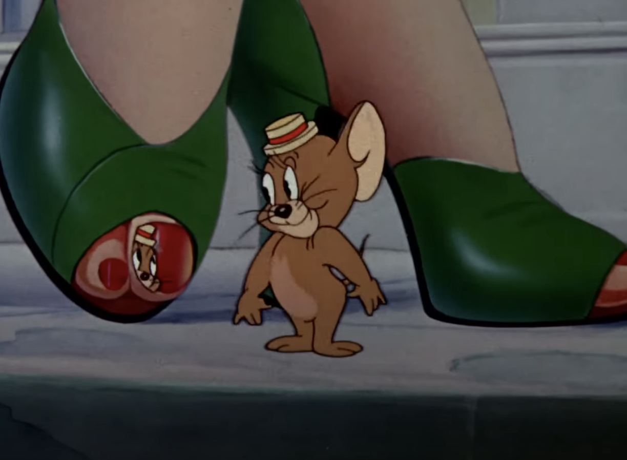 Animated character Jerry from &quot;Tom and Jerry&quot; standing beside green shoes