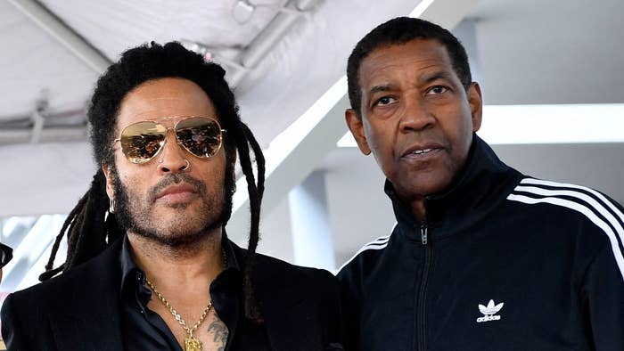 Lenny Kravitz and Denzel Washington posing together, Kravitz in sunglasses and jewelry, Washington in a casual sports jacket