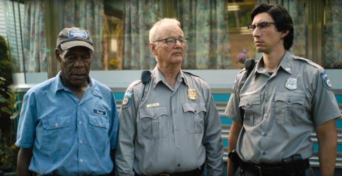 Three actors portraying police officers stand side by side in a still from a film