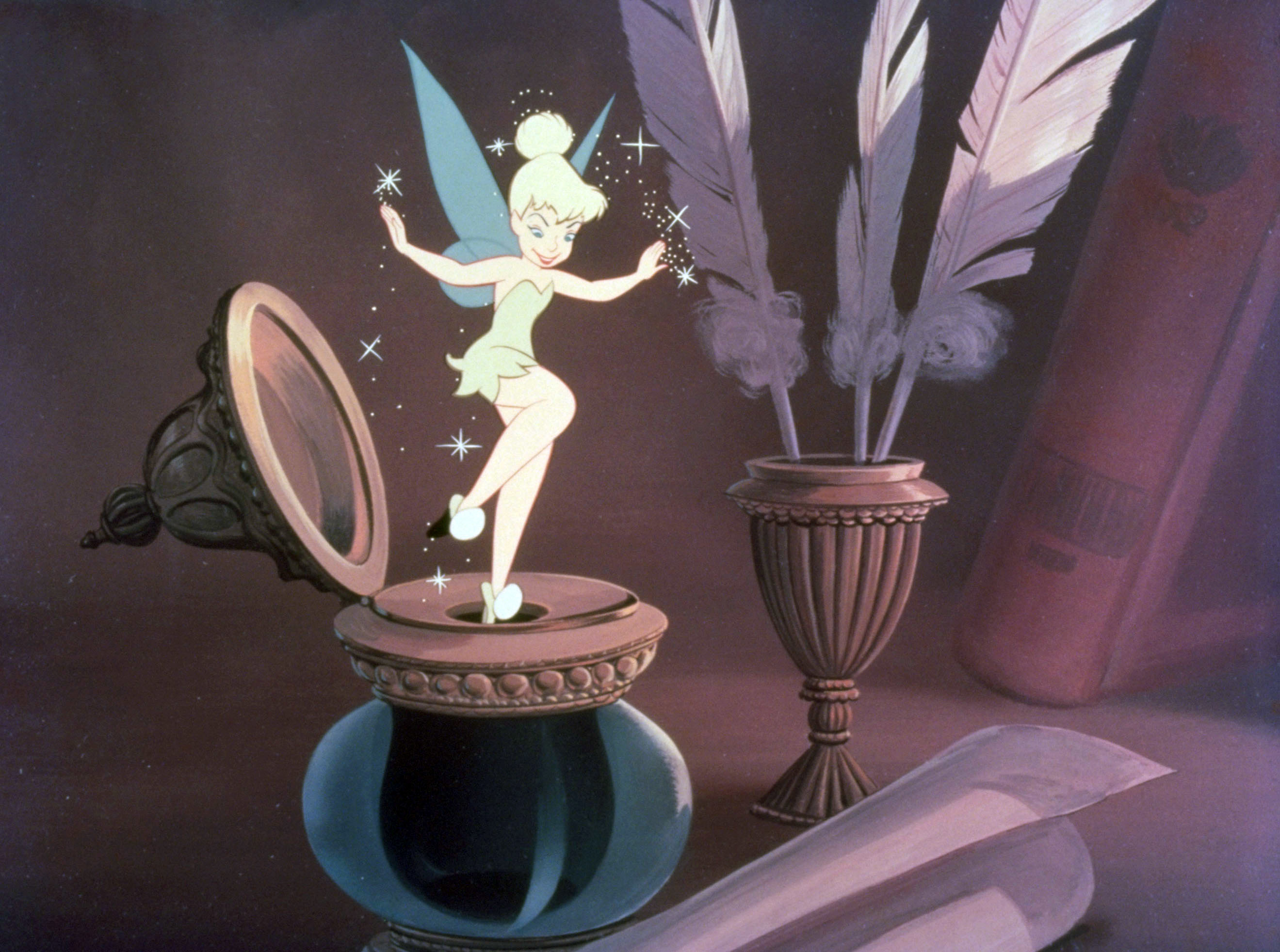 Tinker Bell from Peter Pan is standing on a mirror, with a feather and books in the background