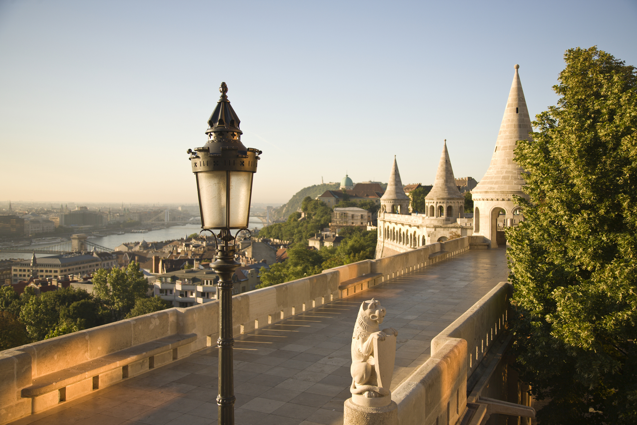 Fisherman&#x27;s Bastion with decorative lamp posts and statues overlooking Budapest cityscape