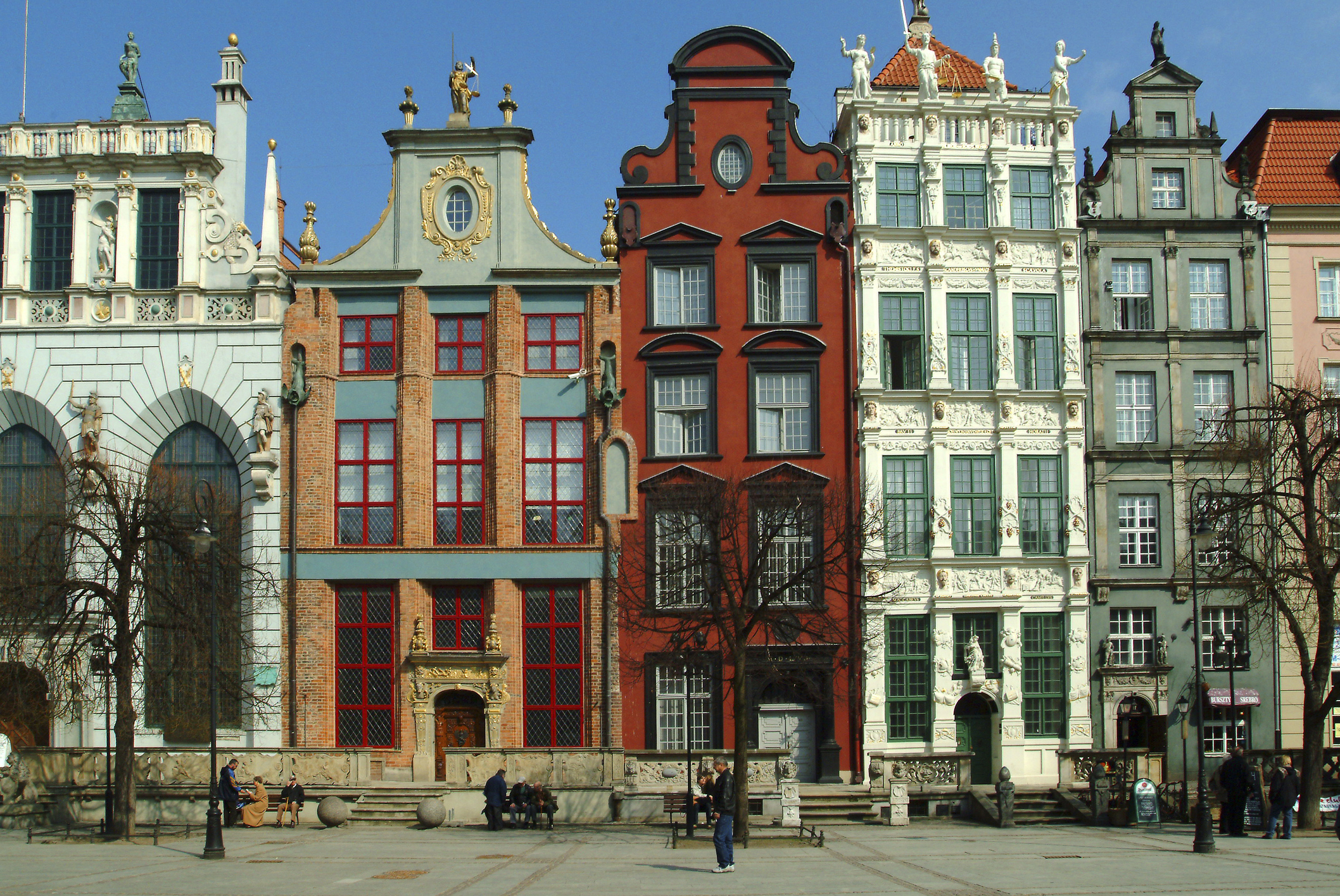 Old Town Square with historical buildings and pedestrians in daylight