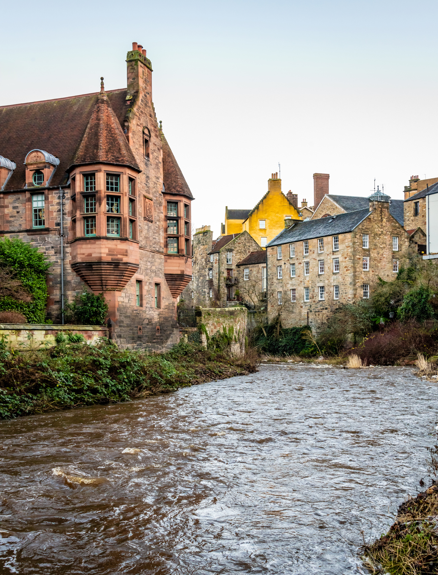 Old stone buildings near a river in Edinburgh, Scotland