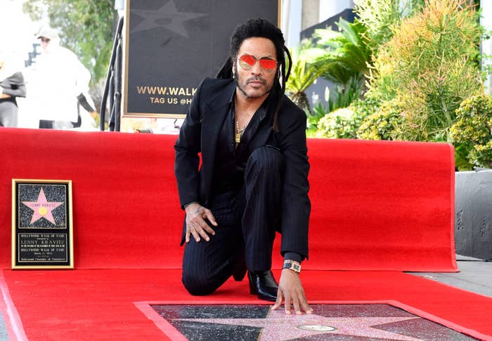 Lenny kneeling beside his star on the Hollywood Walk of Fame, wearing a suit and sunglasses