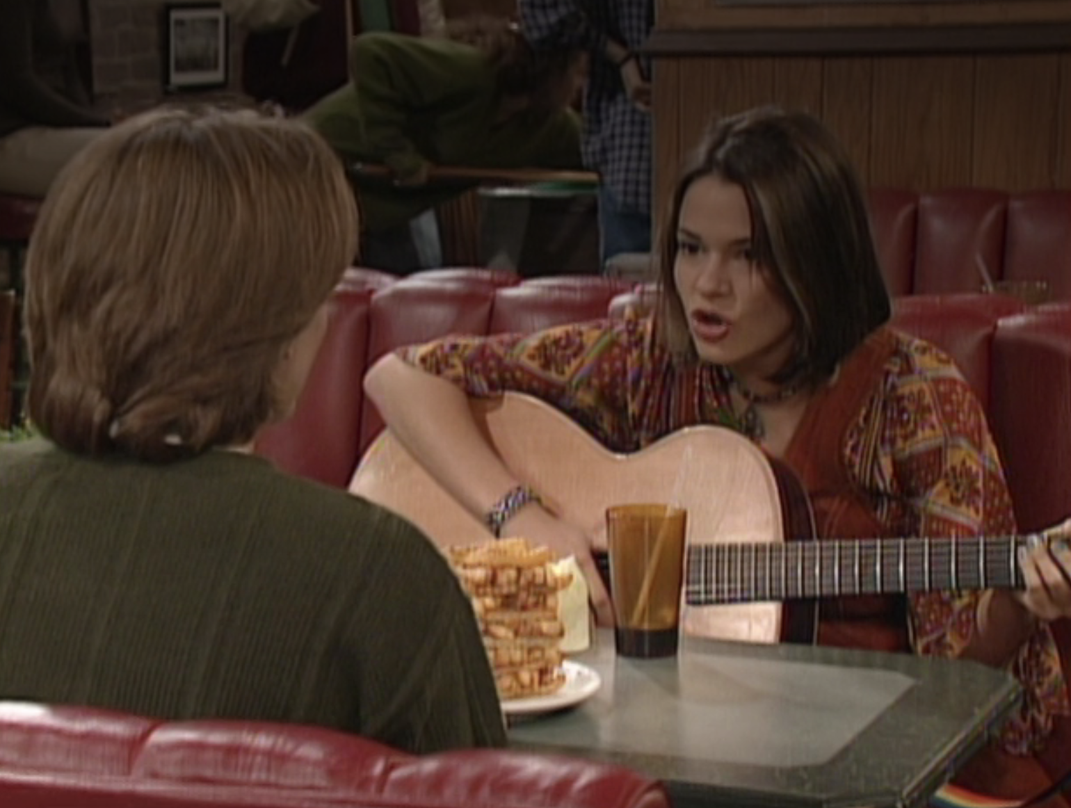 Leisha Hailey playing guitar and singing during her boy meets world appearance