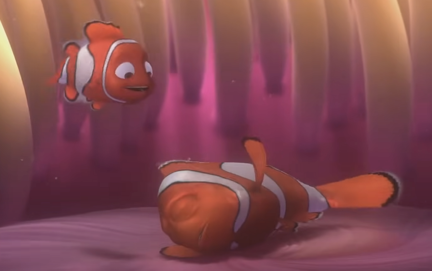 Marlin looking at an exhausted Nemo on the ocean floor