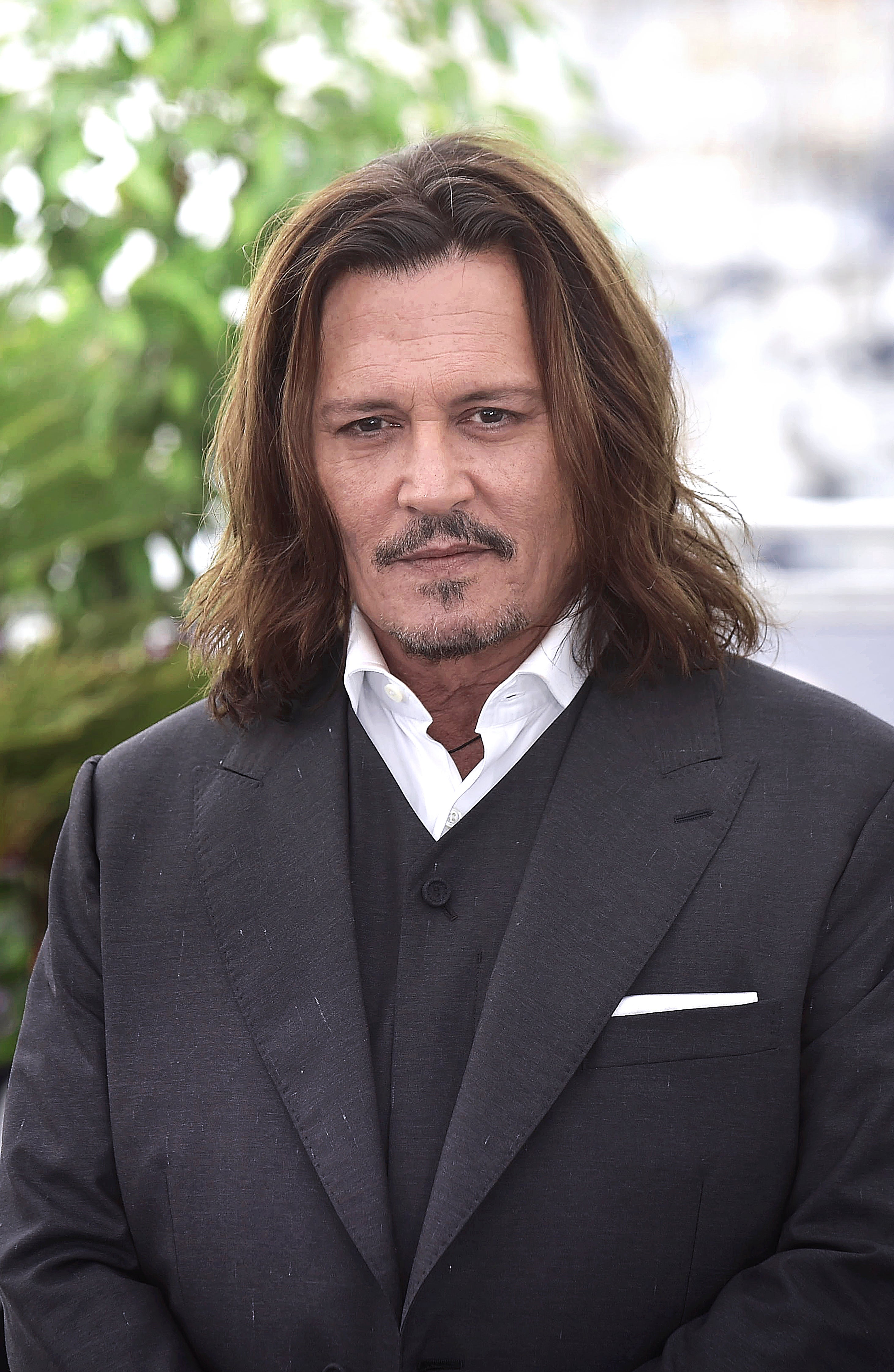 Johnny Depp in a formal black suit at an event
