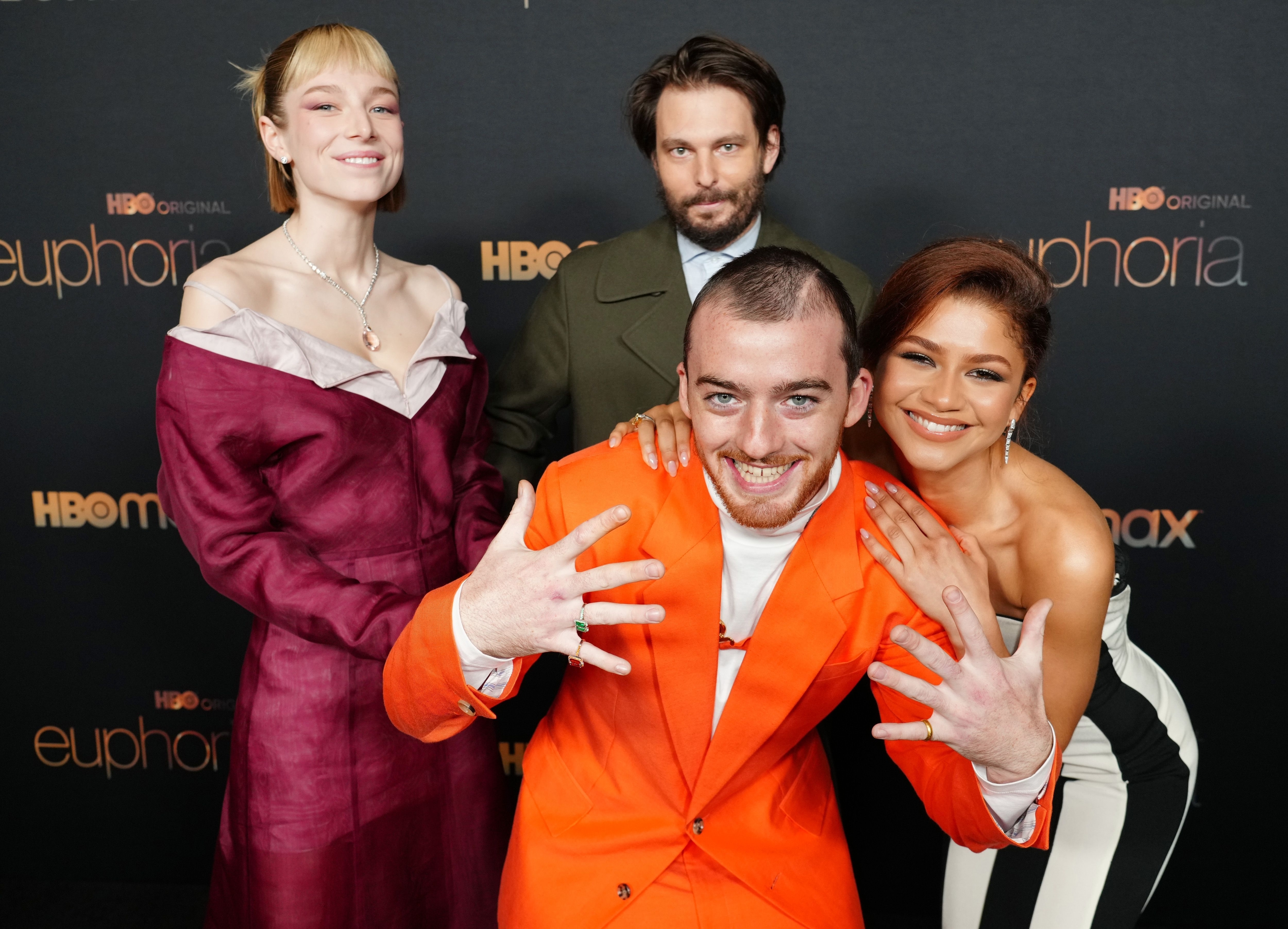Angus Cloud playfully posing for a photo on the red carpet with Zendaya, Sam Levinson, and Hunter Schafer