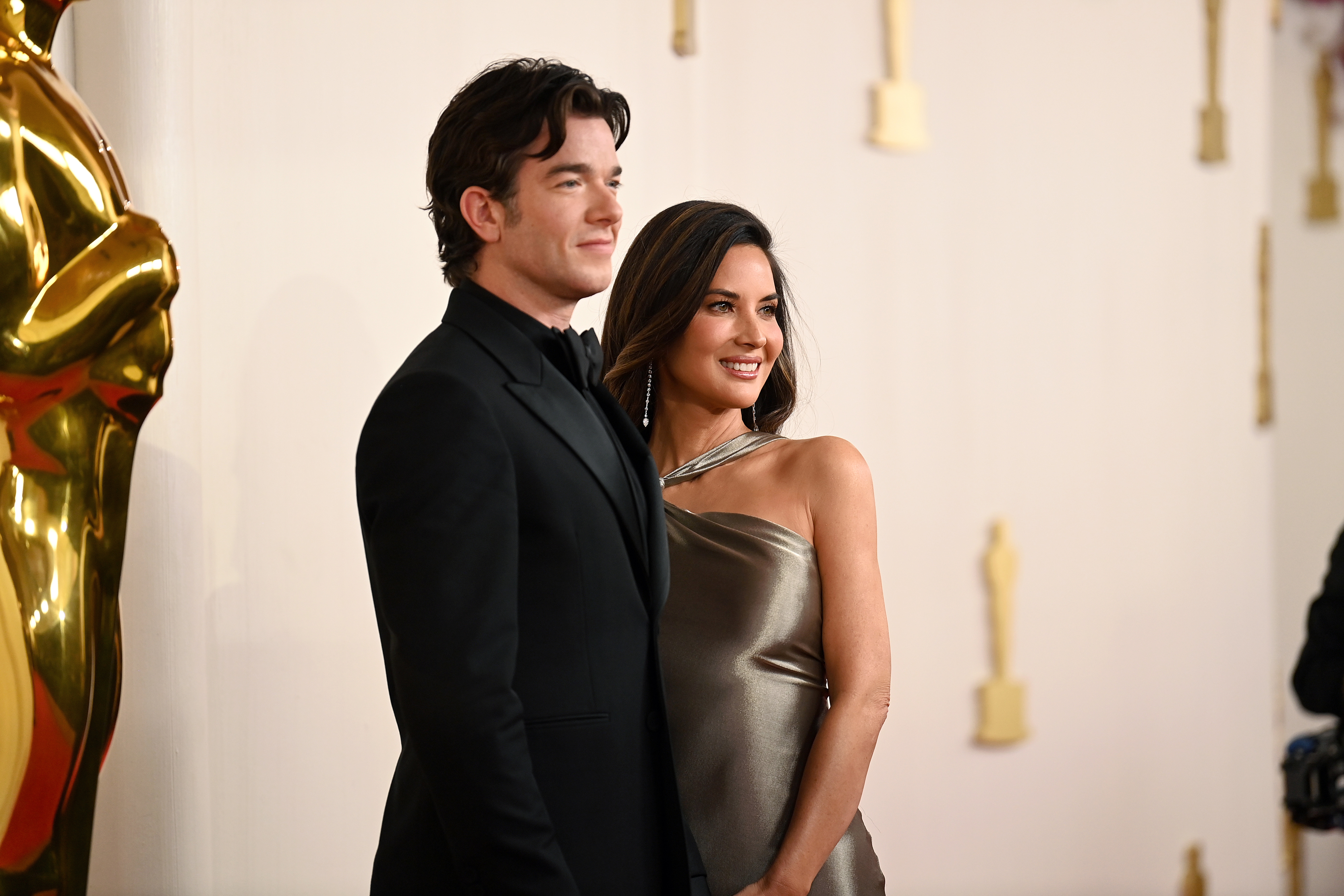 John Mulaney and Olivia Munn pose together for photographers on the red carpet