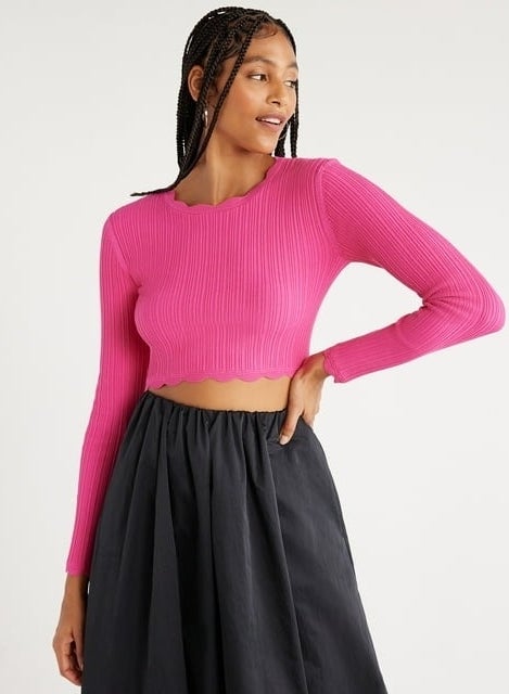 Model wearing long-sleeve pink scallop trim crop top