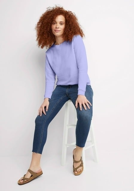 Model wearing purple crewneck sweatshirt