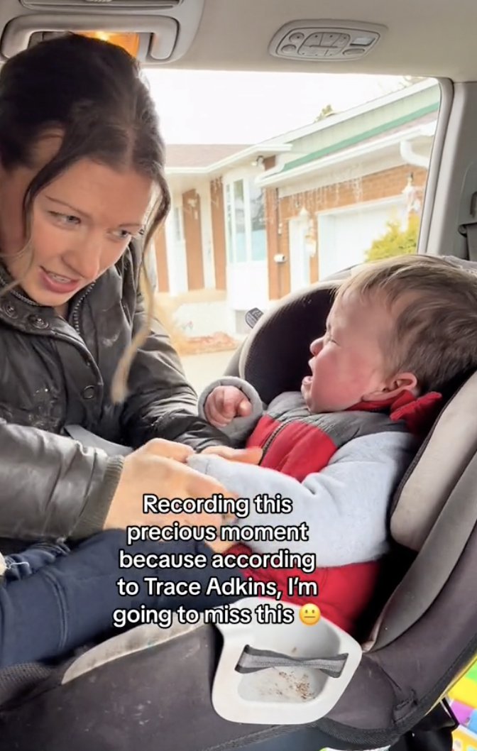 Woman buckling child in car seat as text implies savoring the moment