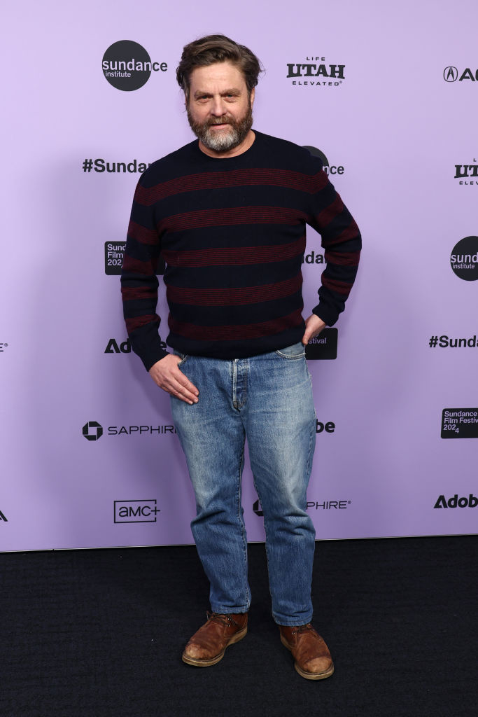 Zach in striped sweater and jeans standing at Sundance Festival backdrop