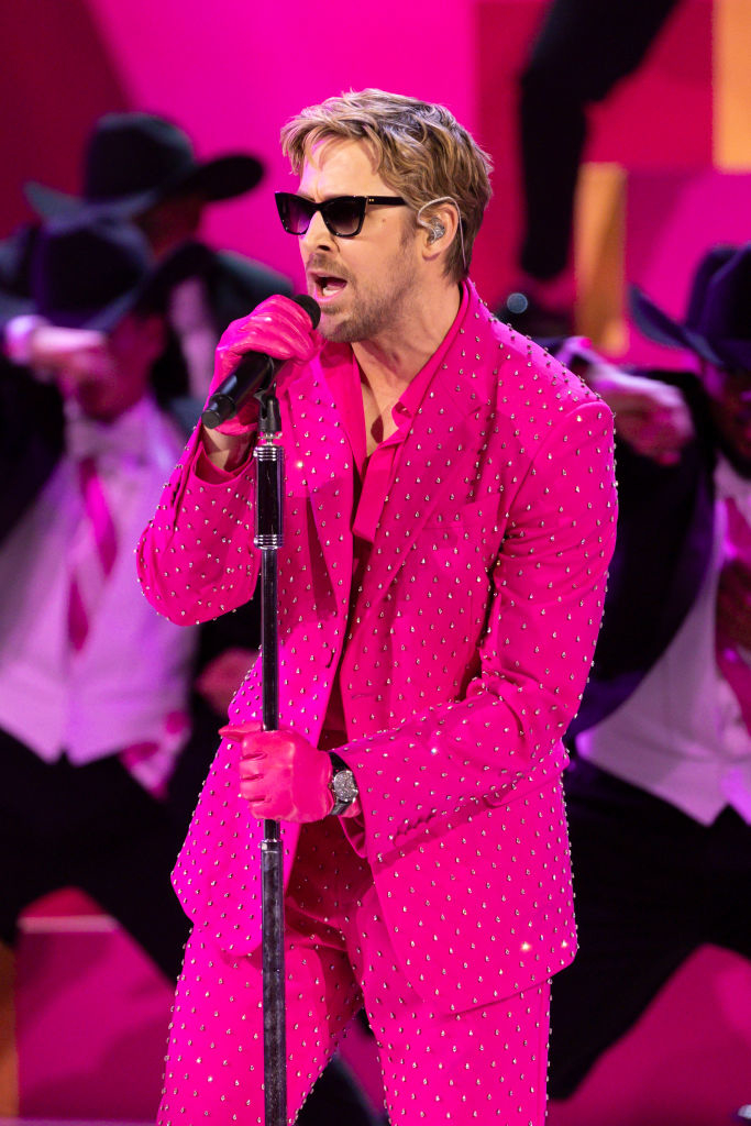 Ryan Gosling is wearing a bedazzled suit while he sings on stage