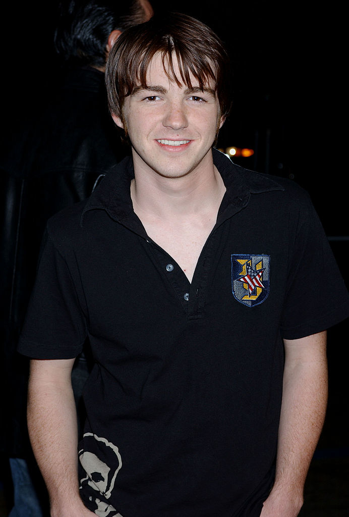 Closeup of a younger Drake Bell outside at night