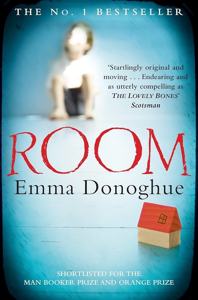 Book cover of &quot;ROOM&quot; by Emma Donoghue with a blurred figure behind a red cardboard house