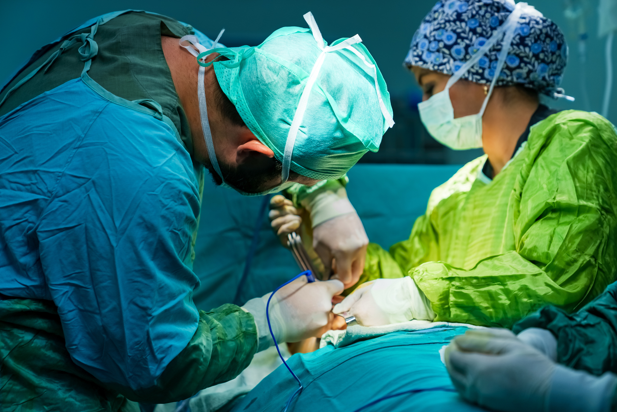 Surgeons in scrubs perform a surgery