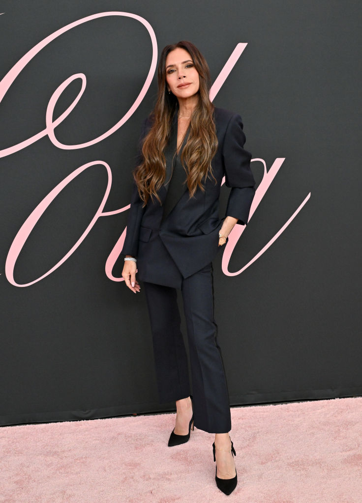 Victoria in a tailored suit and pointy heels