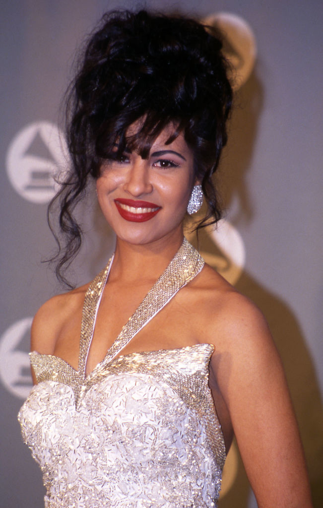 Selena Quintanilla wearing a bustier top with beaded detailing and a high updo hairstyle