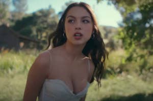 Olivia Rodrigo in a field in the Can't Catch Me Now music video
