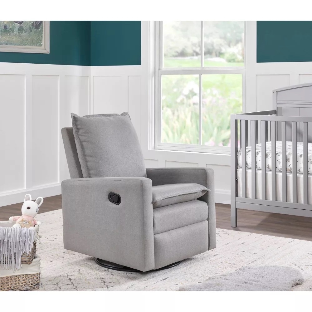 Gray nursery swivel gliding recliner next to a crib