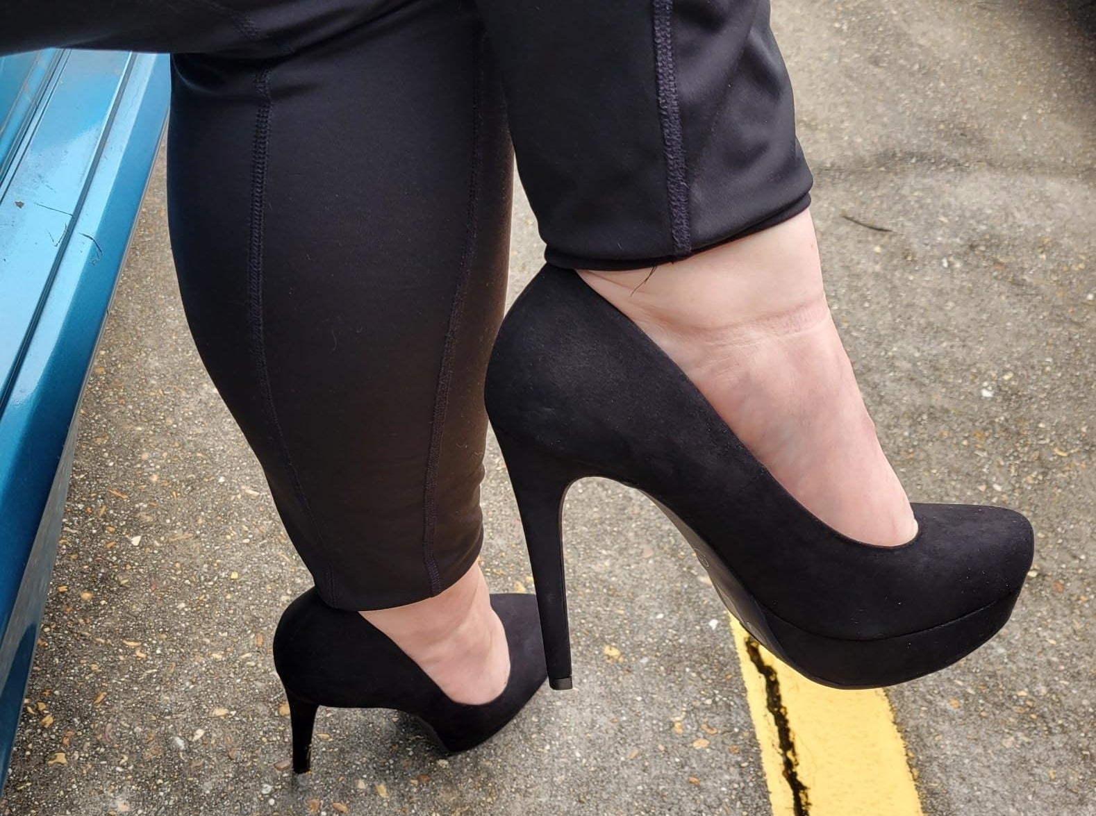 Reviewer wearing the black suede heels