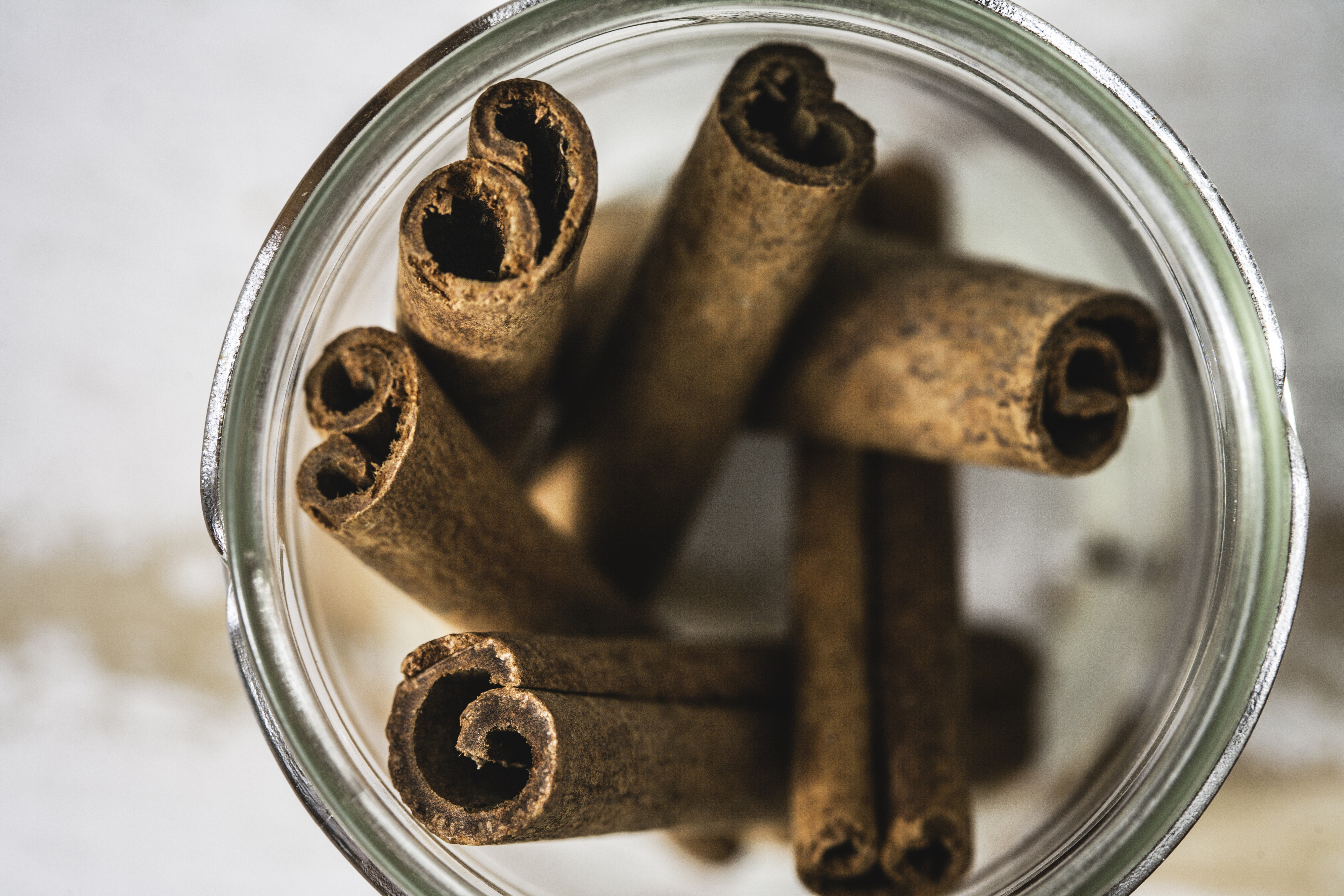 A jar filled with cinnamon sticks viewed from the top