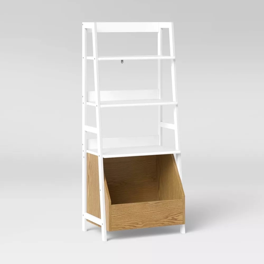 White bookshelf with an angled bottom bin in a contrasting wood finish