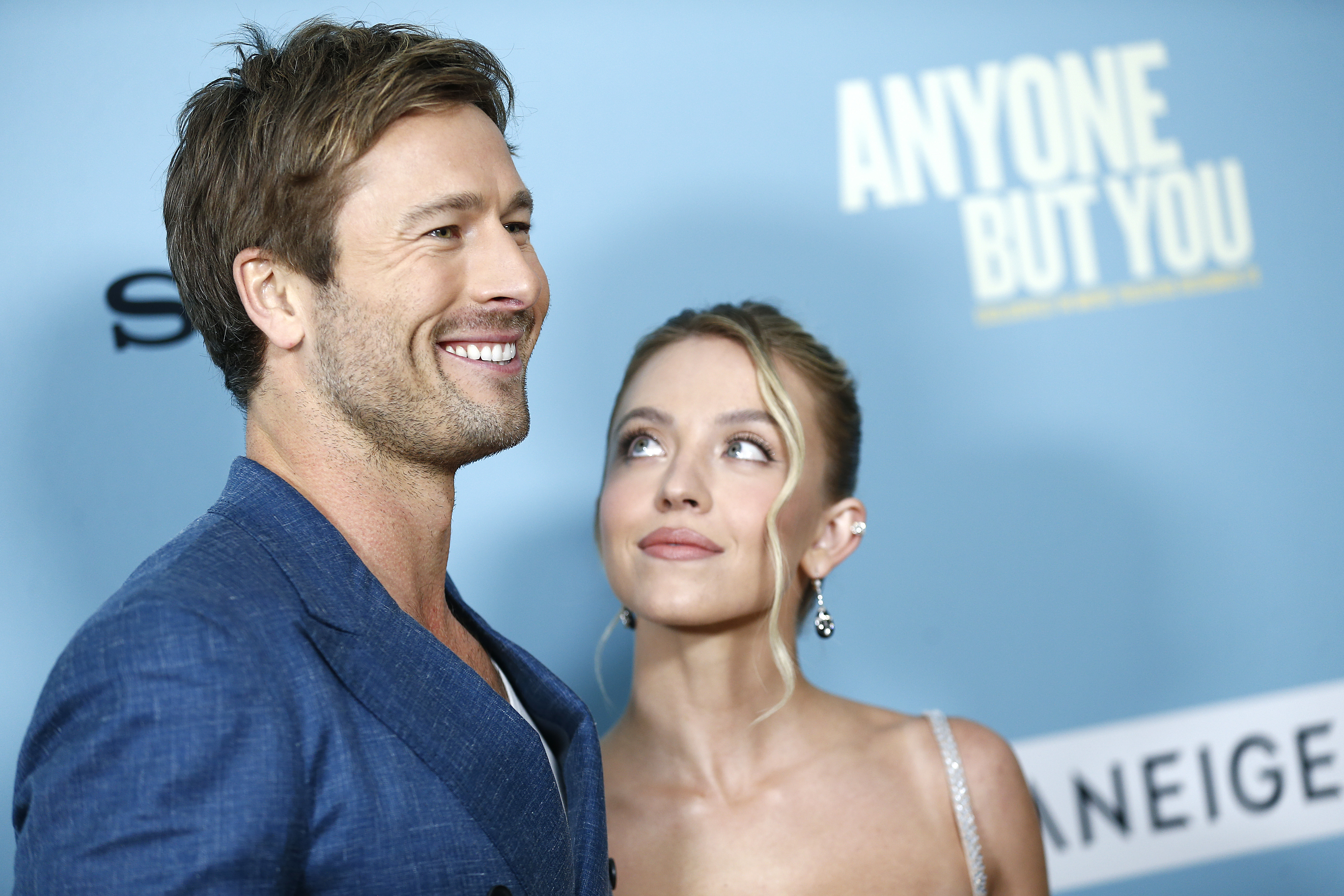 Sydney looking up at her costar Glen Powell at the &quot;Anyone but You&quot; event premiere