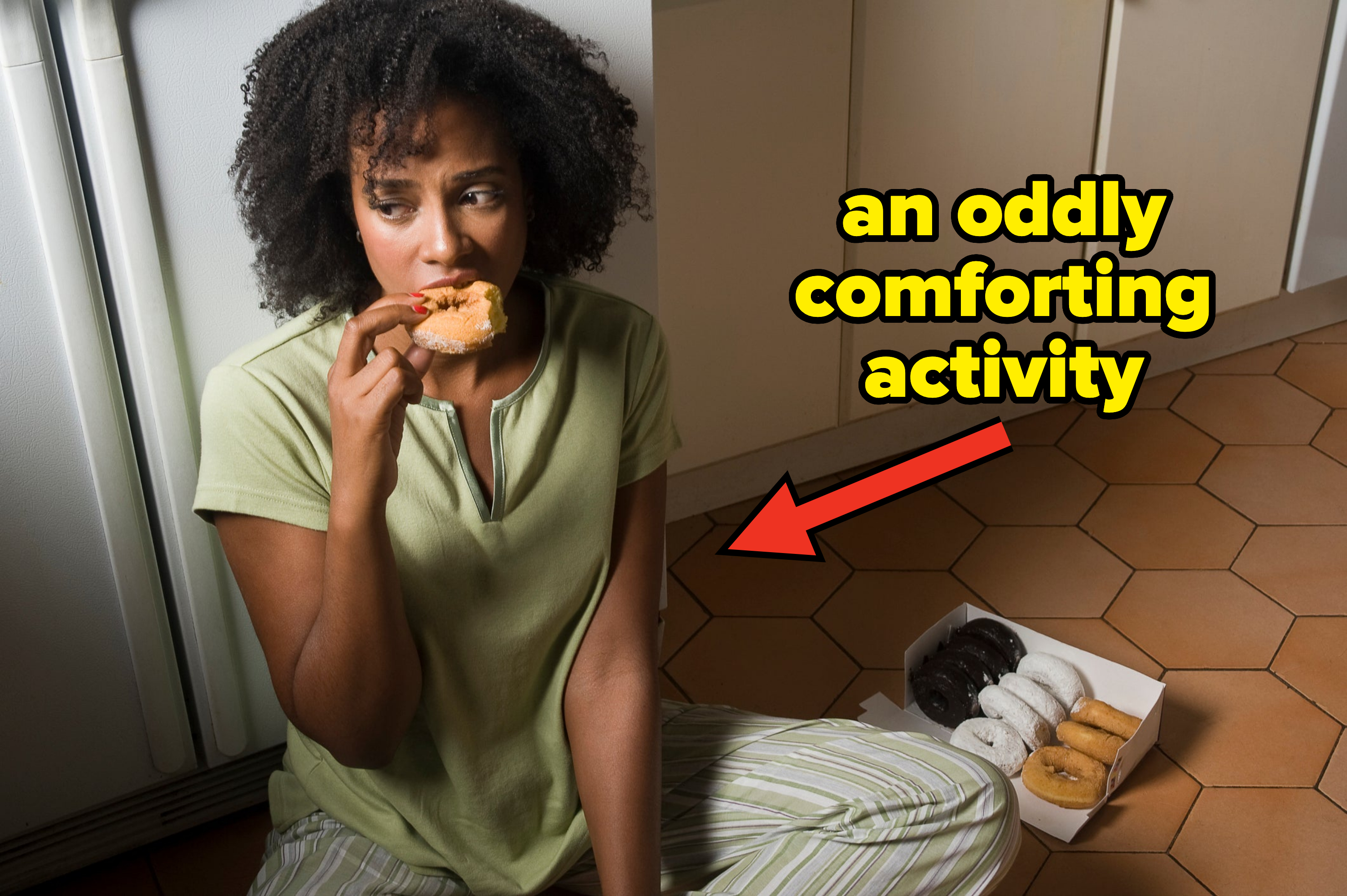 Person sitting on floor eating a cookie, box of assorted cookies nearby
