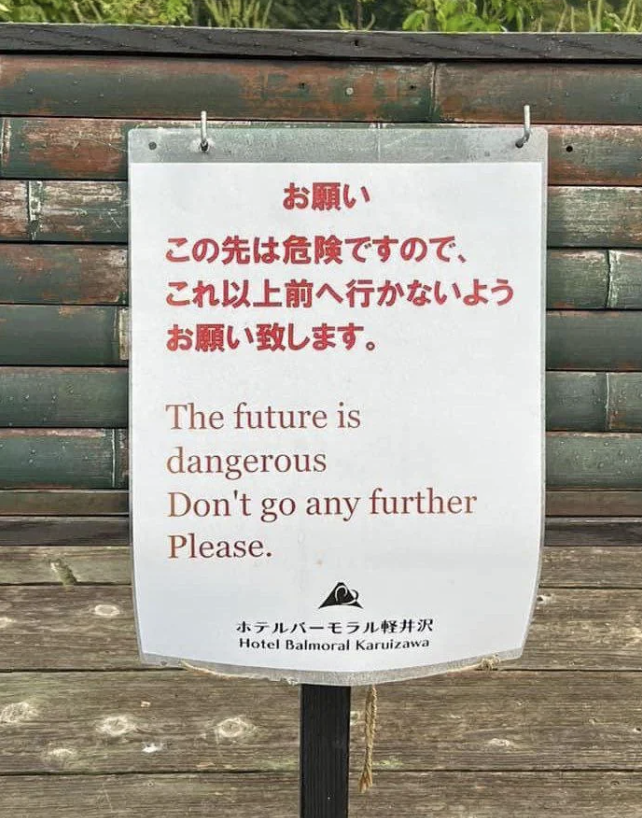 Sign warning &quot;The future is Dangerous. Don&#x27;t go any further&quot; in English and Japanese, possibly humorous
