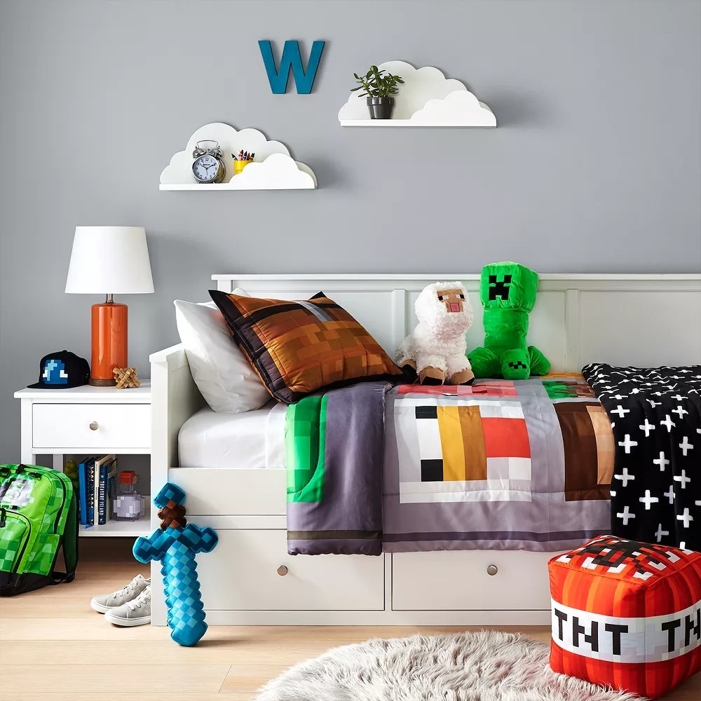 Cloud-shaped shelves on wall above child&#x27;s bed