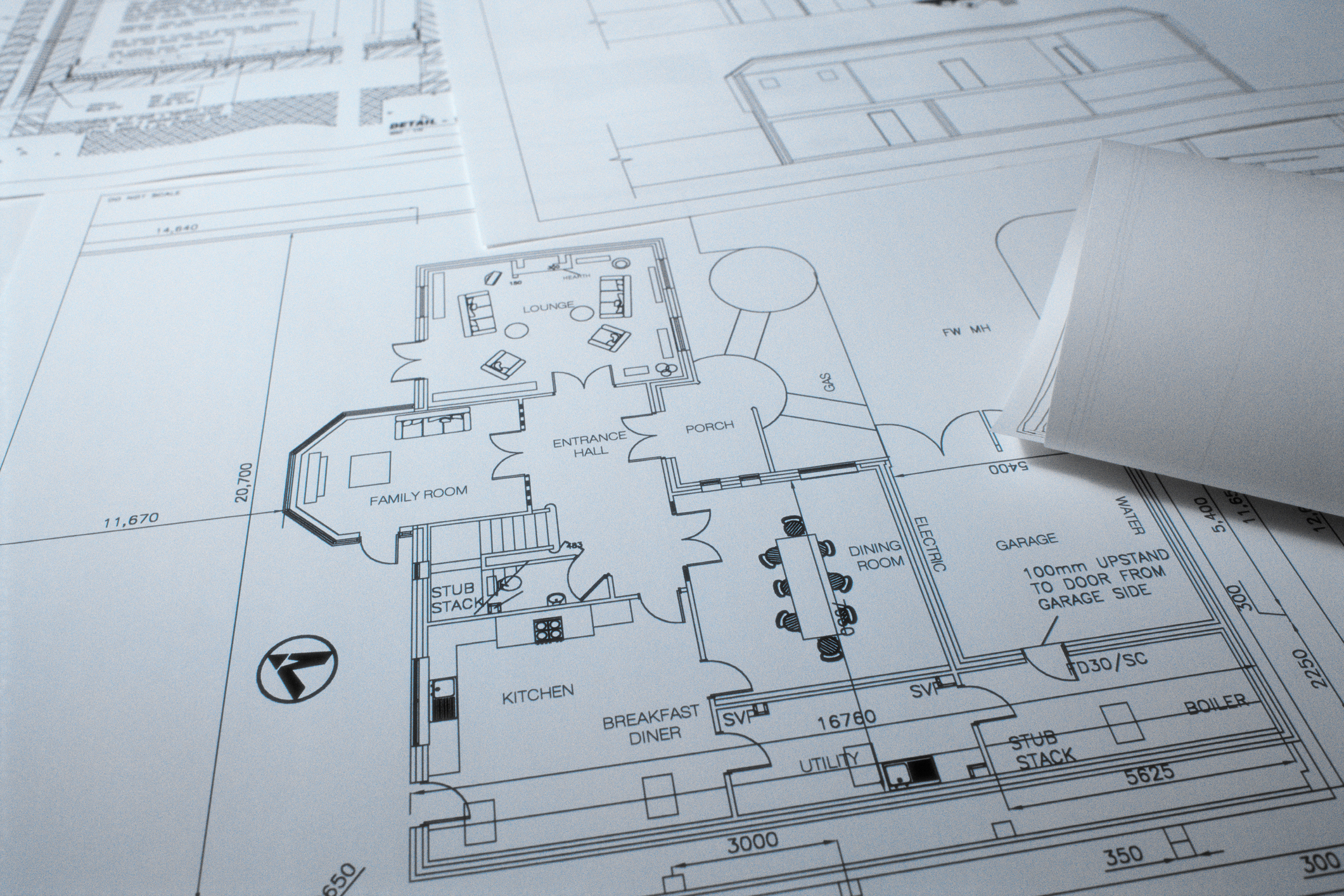 Architectural blueprints with detailed floor plan layouts for a residential house