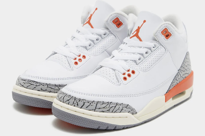 A pair of Air Jordan sneakers with the iconic elephant print and an orange accent