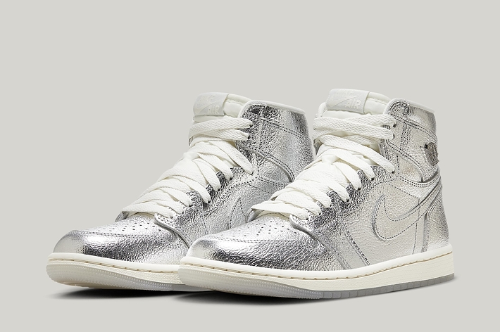 A pair of high-top sneakers with a metallic finish and white laces