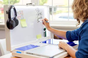 person using pop up workstation with whiteboard