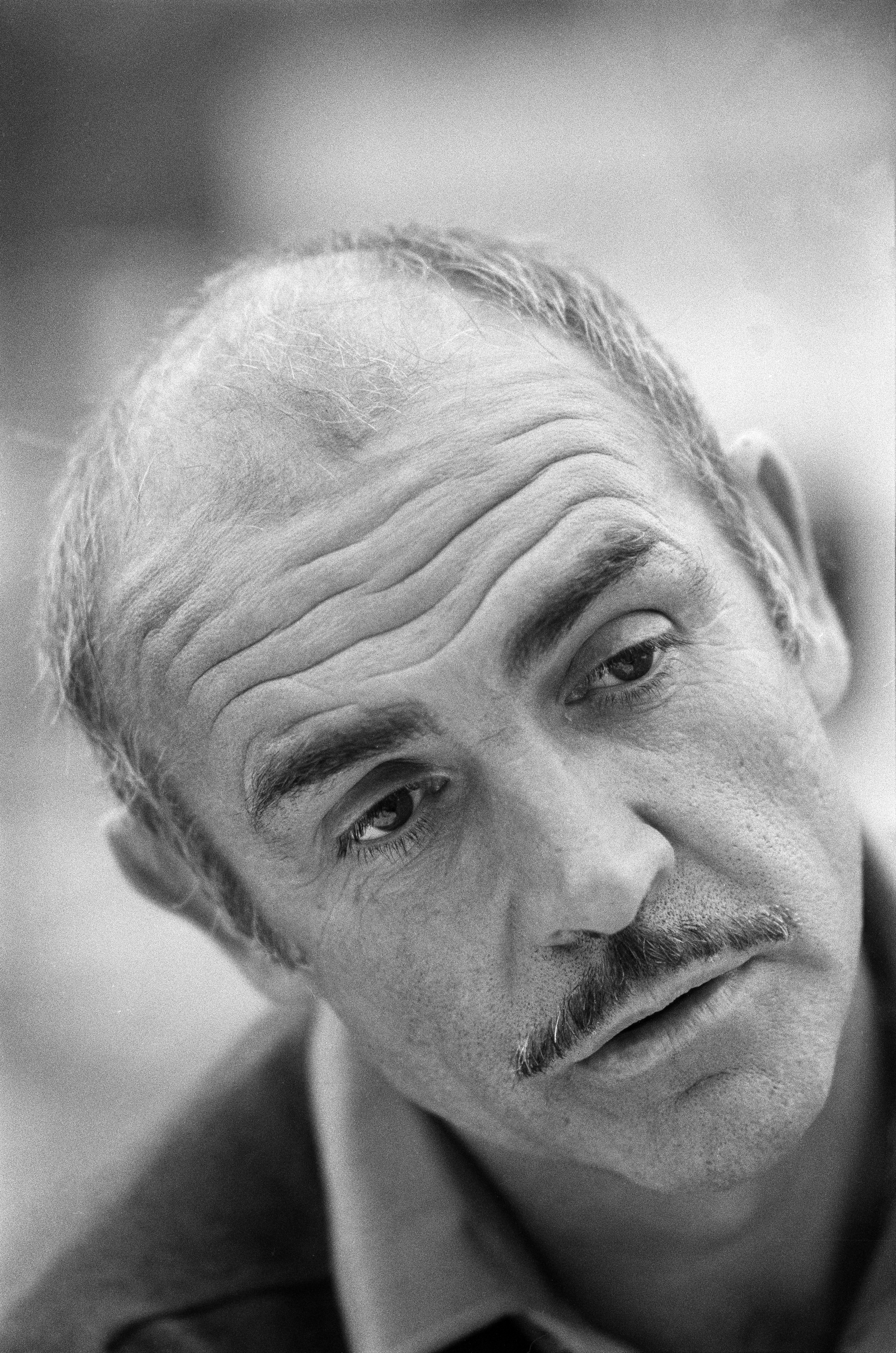 A close-up portrait of Sean Connery with a contemplative expression