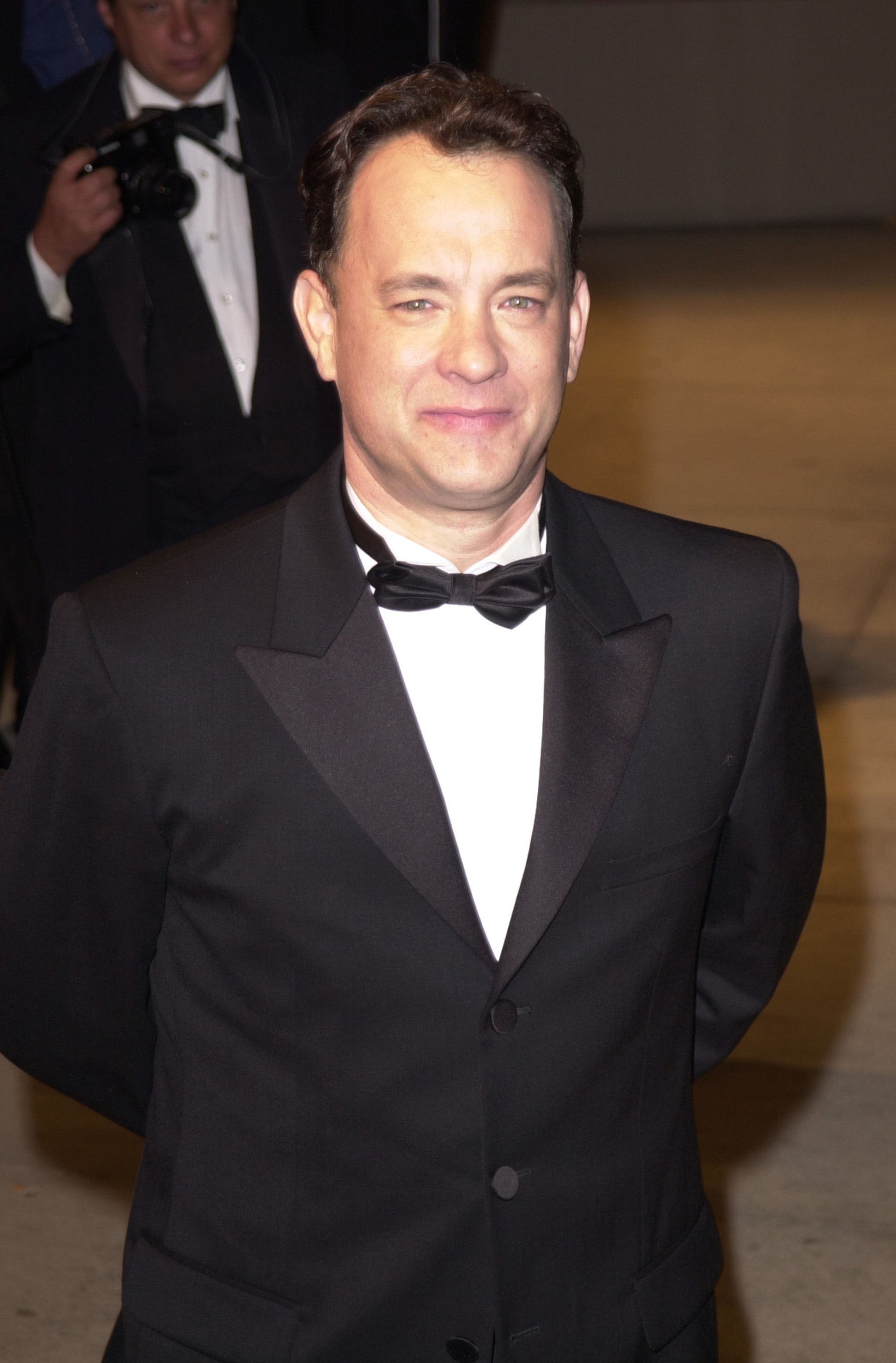 Tom Hanks in a black tuxedo with a bow tie at a formal event