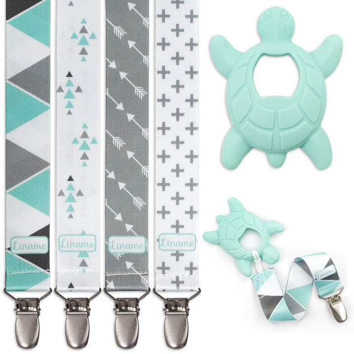 Four pacifier clips with geometric patterns and a silicone turtle teether next to two pacifier clip adaptors