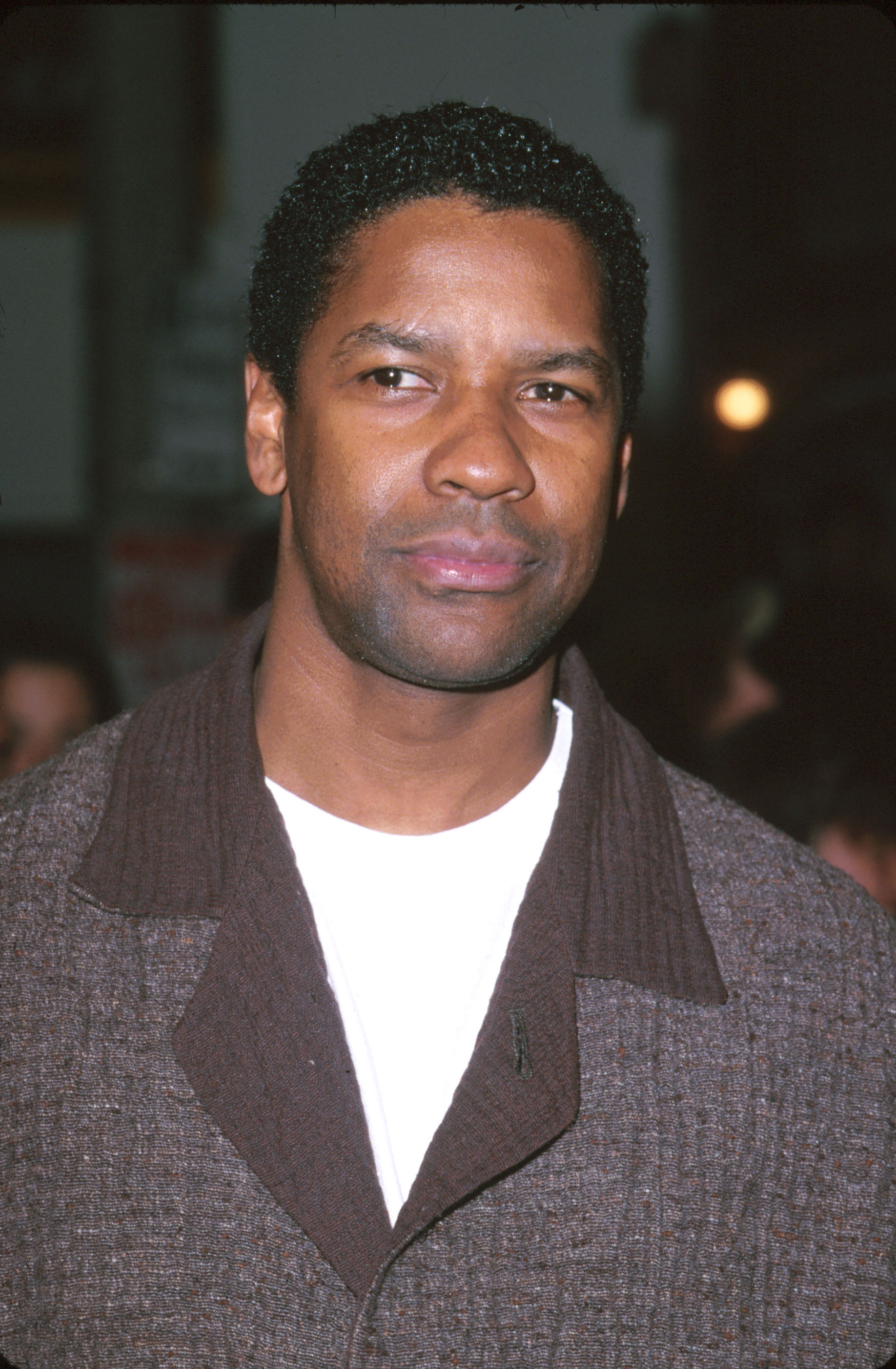 Denzel Washington in a smart casual jacket with a collared shirt at an event